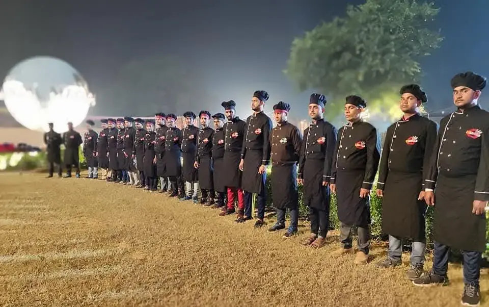 The brigade standing in formation across the event lawn before service begins.