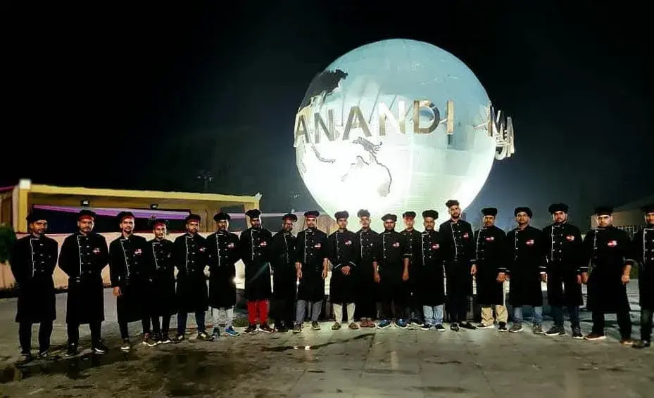 The brigade in formation outside the venue at night.