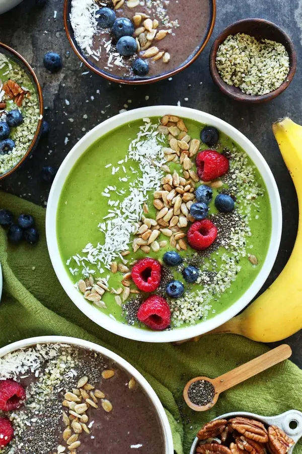 Smoothie bowls dressed with fruit, nuts and seeds.