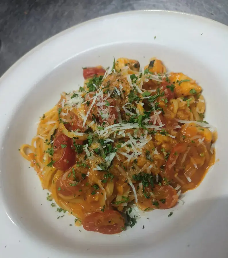 A seafood pasta plated for service.