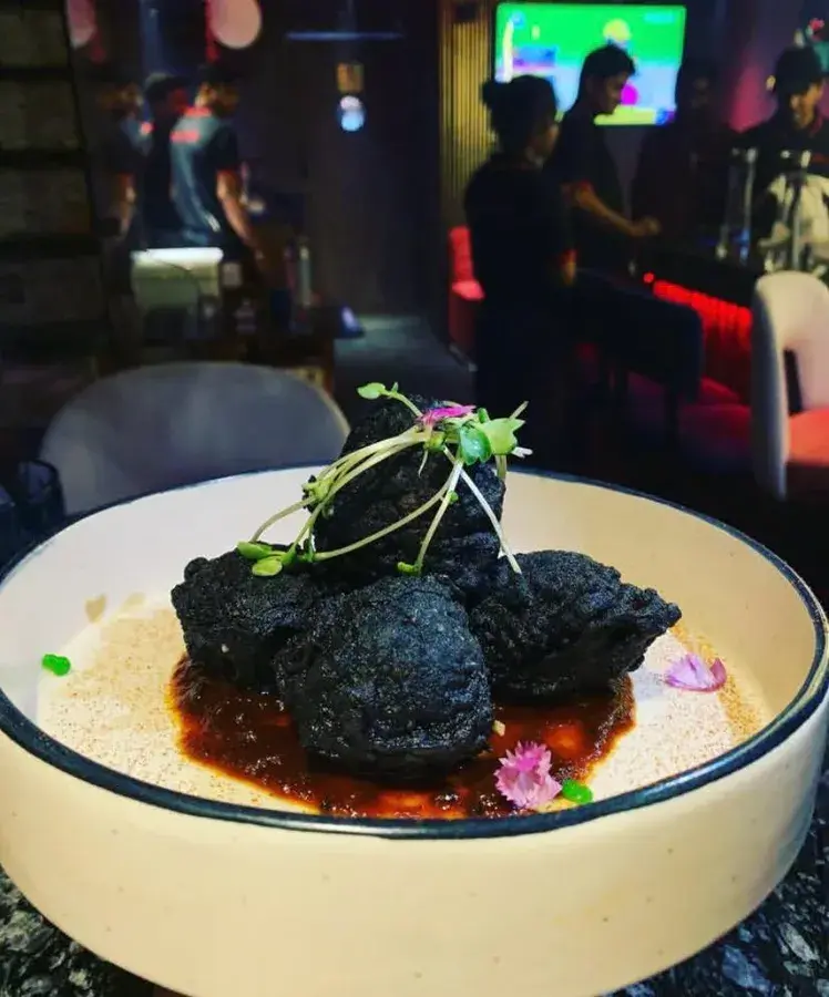 A plated dish presented in a bar setting.