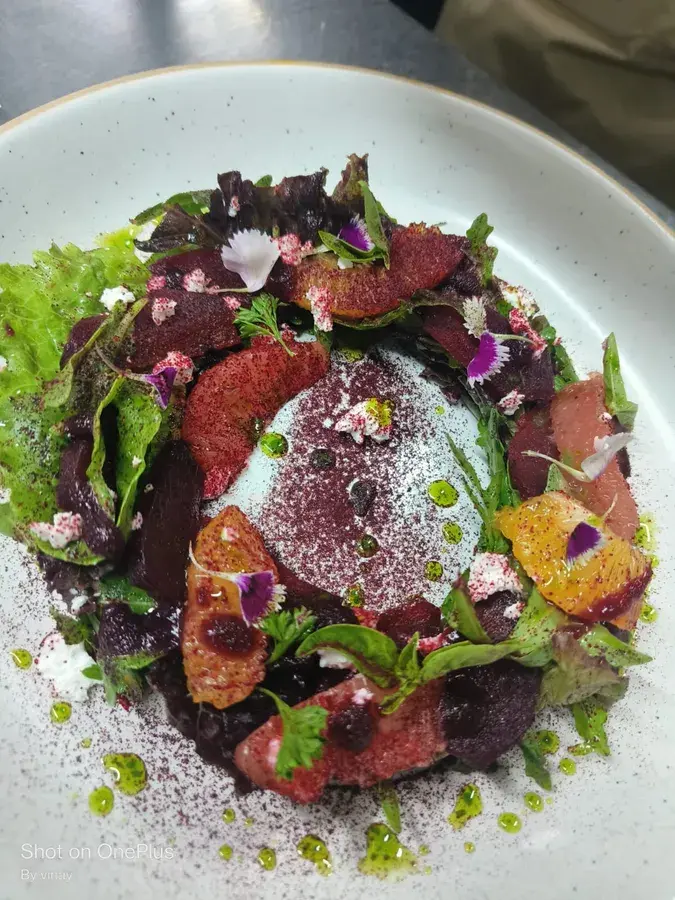 A dressed salad with beetroot and leaves.