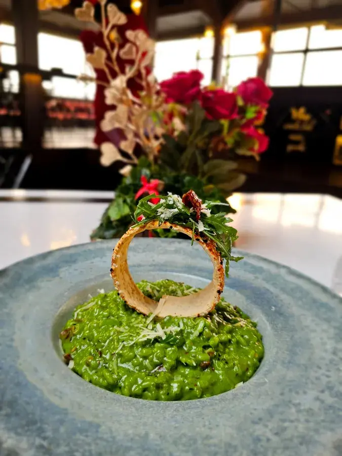 A dessert presentation with a floral garnish.