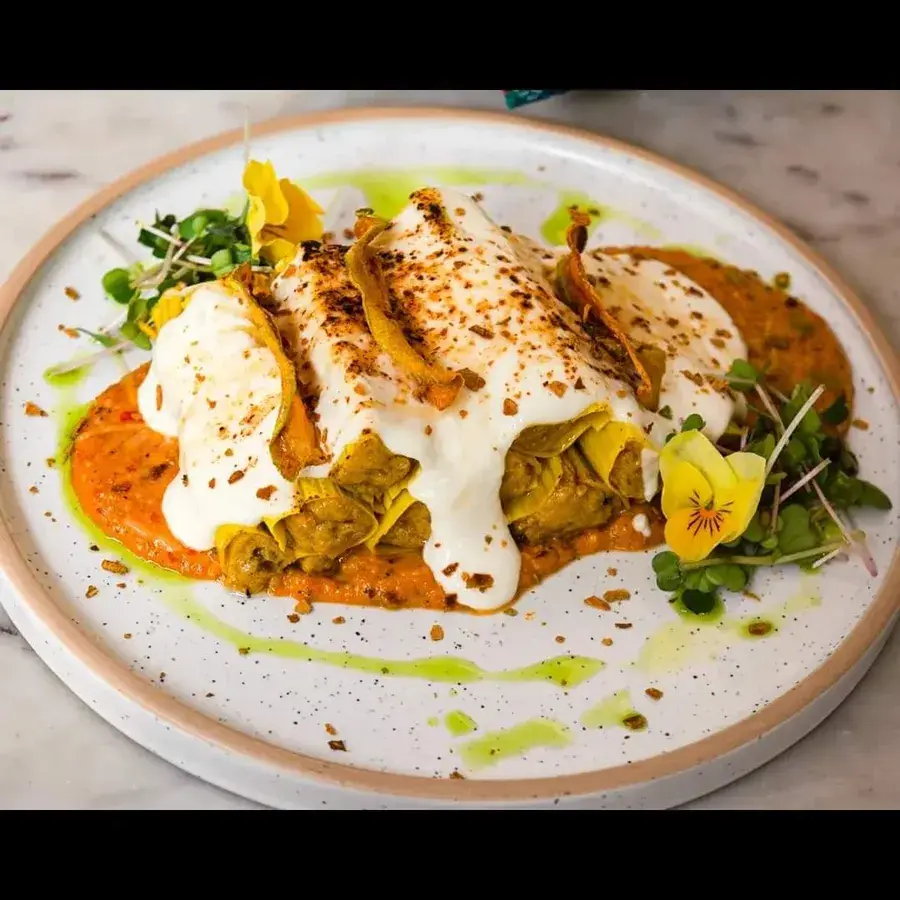 A plated main finished with a saffron sauce.