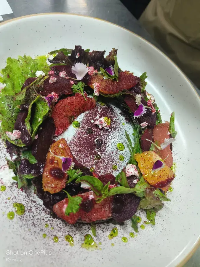 A beetroot and leaf salad plated for service.