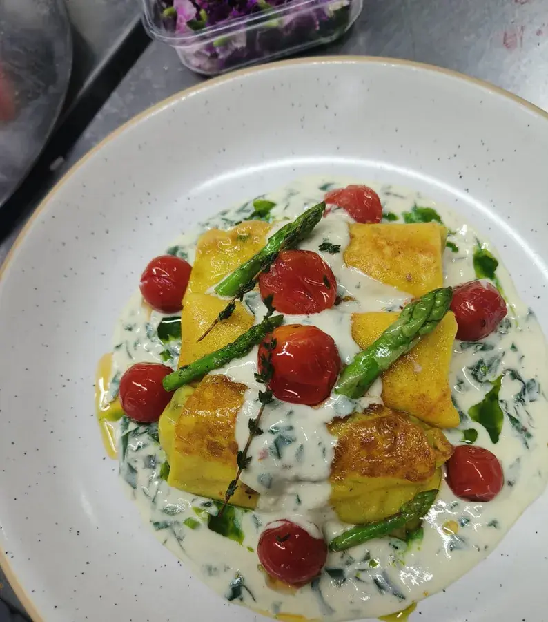 Gnocchi with asparagus and tomato.