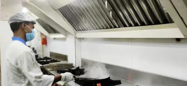 A chef working the range under extraction.