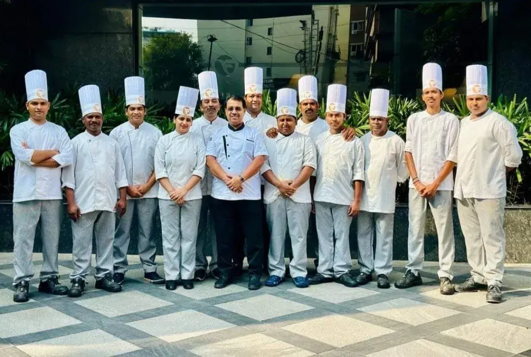 A chef brigade in full whites outside the venue.