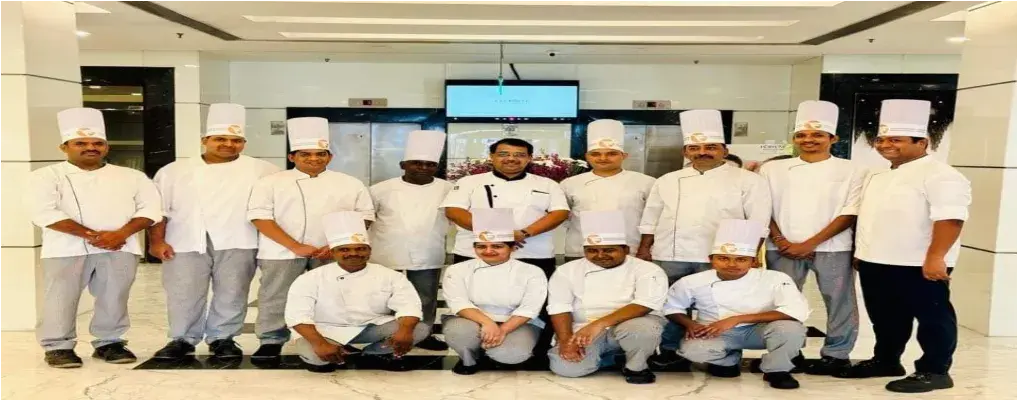 A chef brigade assembled indoors.