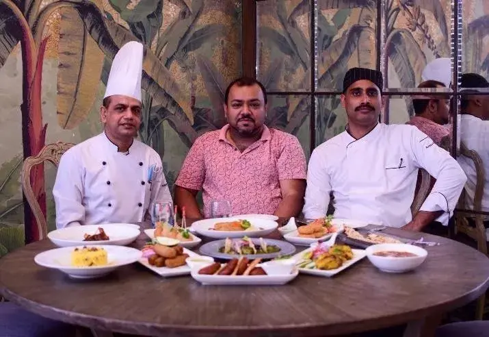 Chefs presenting a tasting menu at the pass.