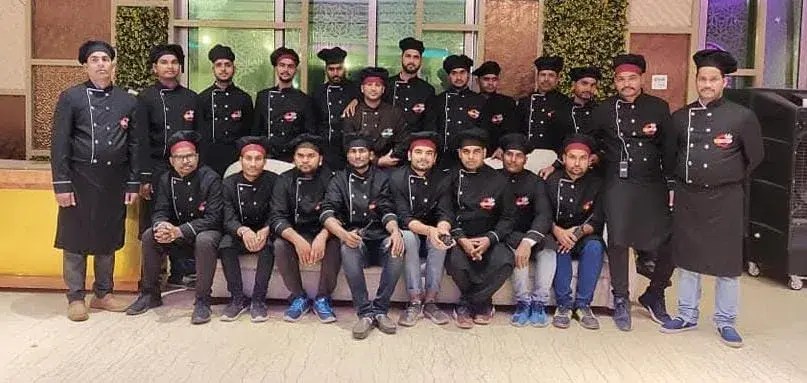 The service team assembled indoors in full uniform.