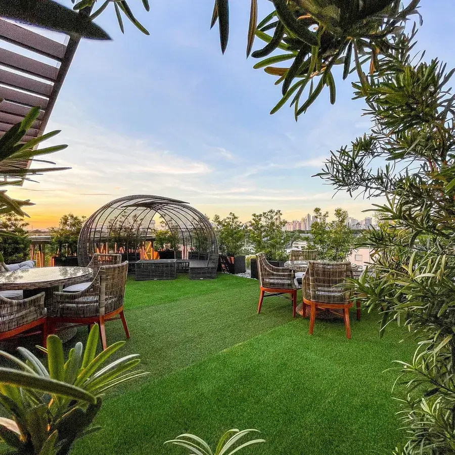 A rooftop dining terrace at dusk.