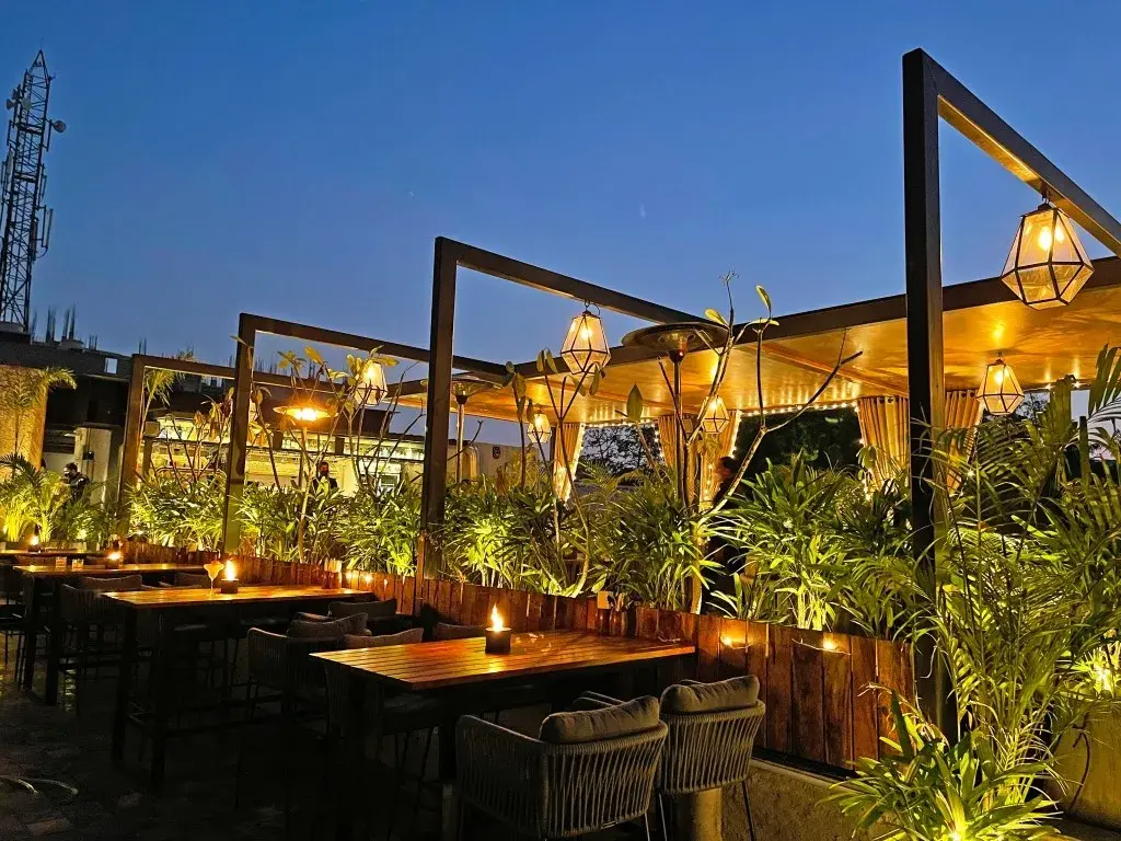 A rooftop restaurant lit for evening service.